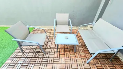 a group of chairs and a table with a laptop at 4 Bedroom Home with Pool near Canggu and Seminyak in Kerobokan