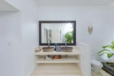 a bathroom with two sinks in front of a mirror at Villa Naema by Pertama Management in Seminyak