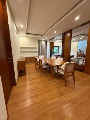 a dining room with a wooden table and chairs at Avela bali villa in Kerobokan