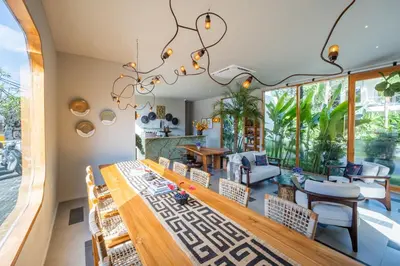 a dining room with a large chandelier at Anam Tang New Rooms & Cafe near Seminyak in Seminyak