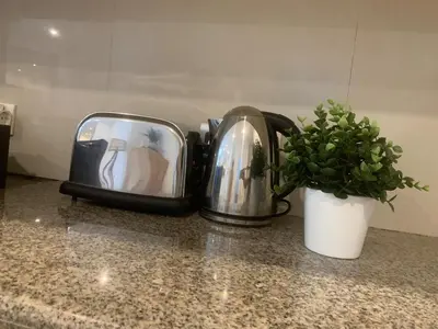 a toaster sitting on a counter next to a potted plant at Heart of Seminyak 2bed 2bath 2 pools super quiet in Seminyak