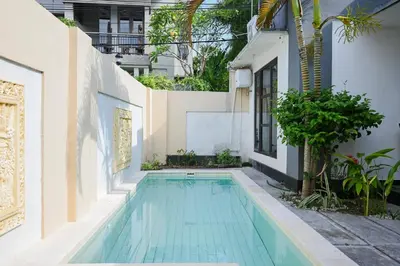 a swimming pool in the courtyard of a house at Villa Taman Sari in Nusa Dua