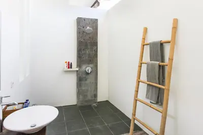 a bathroom with a toilet and a sink and a ladder at Villa Turtle in Seminyak