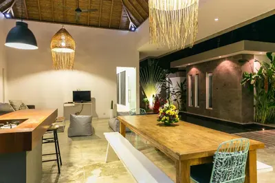 a dining room with a table and chairs at Villa Turtle in Seminyak