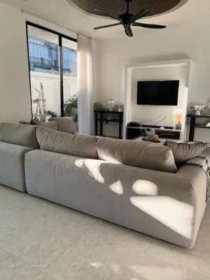 a large gray couch in a living room at Deo Villa Seminyak in Seminyak