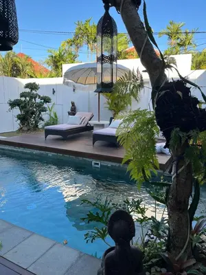a villa with a swimming pool and a resort at Deo Villa Seminyak in Seminyak