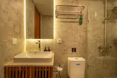 a bathroom with a sink and a toilet and a shower at Premier Umalas Villa by Betterplace in Canggu