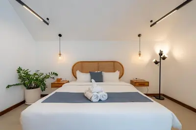 a bedroom with a large white bed with two towels at Premier Umalas Villa by Betterplace in Canggu