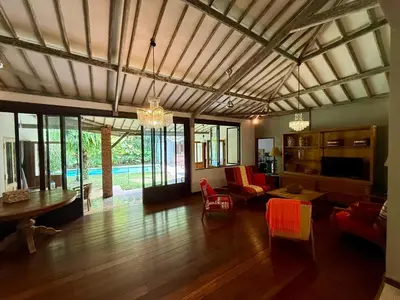 a living room with a couch and a table at Villa Olita in Canggu