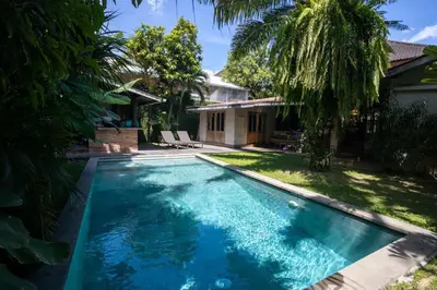 a swimming pool in the backyard of a house at Villa Olita in Canggu