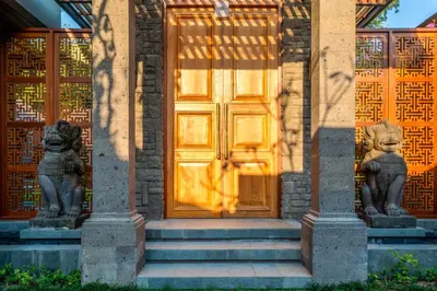 a door with two statues in front of a building at Jeeva Tirta Seminyak in Canggu