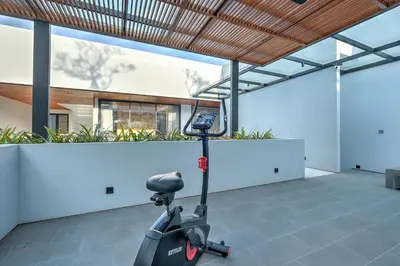a scooter parked in a room with a building at Villa Brandon by Nakula in Jimbaran