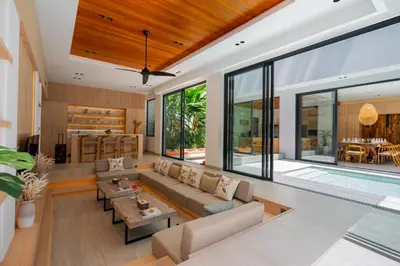 an open living room with a couch and a table at Villa Brandon by Nakula in Jimbaran