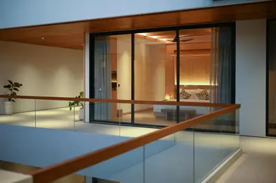 a view of a house with glass walls at Villa Brandon by Nakula in Jimbaran