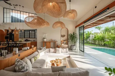 a living room with a swimming pool and a villa at New SASS Villa - Stylish & Modern 3BR at Seminyak in Seminyak