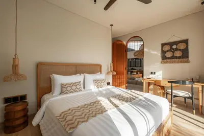 a bedroom with a large bed and a desk at New SASS Villa - Stylish & Modern 3BR at Seminyak in Seminyak
