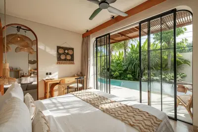 a bedroom with a bed and a large window at New SASS Villa - Stylish & Modern 3BR at Seminyak in Seminyak