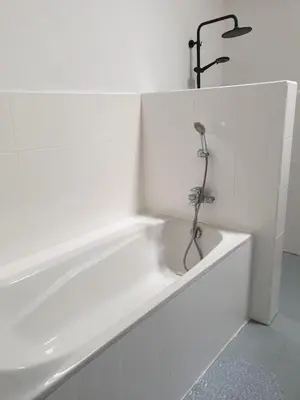 a bathroom with a bath tub and a sink at Vina villa in Kerobokan
