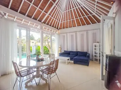 a living room with a table and a blue couch at villa Bunga in Seminyak