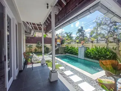 a swimming pool in the middle of a house at villa Bunga in Seminyak
