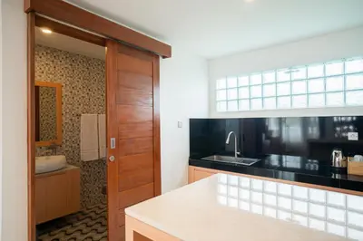 a kitchen with a sink and a counter top at Aspen bali nusa dua in Nusa Dua