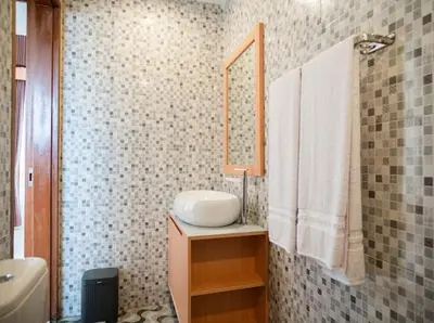 a bathroom with a sink and a mirror at Aspen bali nusa dua in Nusa Dua