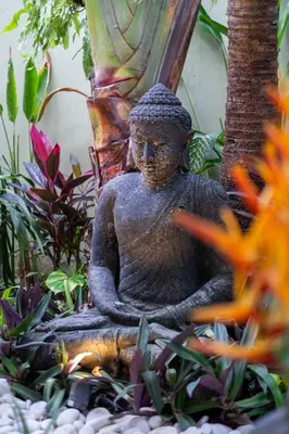 a statue of a meditating person in a garden at Spacious Charming 4BR Balinese Villa, Seminyak in Kerobokan