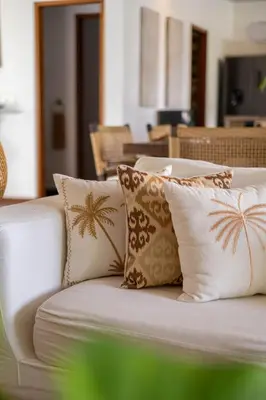 a white couch with four pillows on it at Spacious Charming 4BR Balinese Villa, Seminyak in Kerobokan