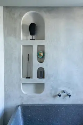 a bathroom with a sink and shelves on a wall at Hanupis Canggu Apartment in Canggu
