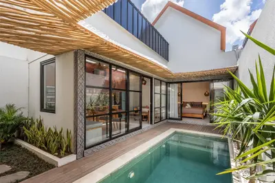 an external view of a house with a swimming pool at Modern and Petite 2bd Seminyak Villa Construction Near in Seminyak