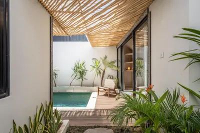 an indoor pool in a house with plants at Modern and Petite 2bd Seminyak Villa Construction Near in Seminyak