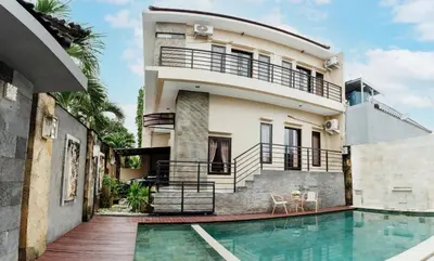 a house with a swimming pool in front of it at Unique Villa Jimbaran in Jimbaran