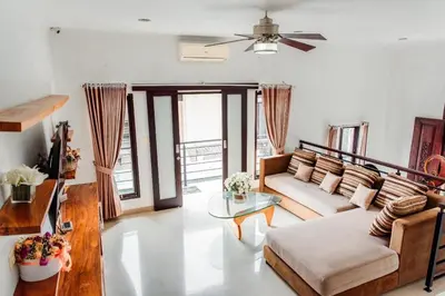 a living room with a couch and a table at Unique Villa Jimbaran in Jimbaran