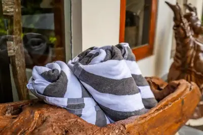 a blanket sitting on top of a wooden basket at Villa Durna 2 in Seminyak