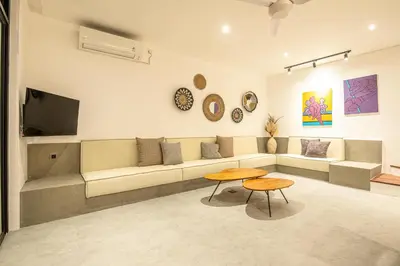 a living room with a couch and a table at Tropical 5BR Modern Haven 400m from Canggu in Canggu