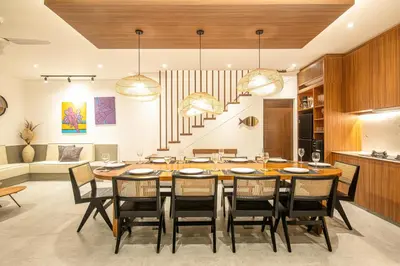 a dining room with a large wooden table and chairs at Tropical 5BR Modern Haven 400m from Canggu in Canggu