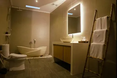 a bathroom with a tub and a sink and a toilet at Villa Sinergi Seminyak 7 in Seminyak
