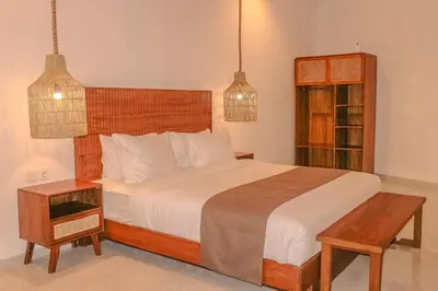 a bedroom with a large bed and two pendant lights at Villa Sinergi Seminyak 7 in Seminyak