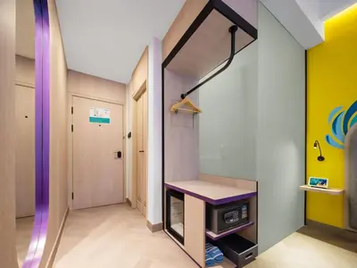 a room with a kitchen with a stove in it at Quest Vibe Dewi Sri Bali in Legian