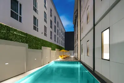 a swimming pool in the middle of a building at Quest Vibe Dewi Sri Bali in Legian