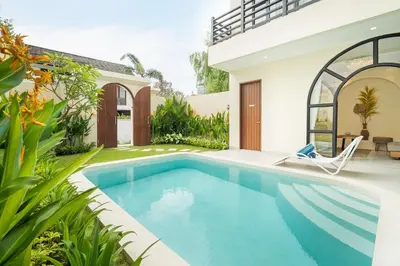 a swimming pool in the backyard of a house at Villa Amaia Bali in Kerobokan