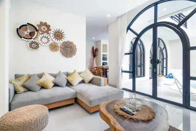 a living room with a couch and a table at Villa Amaia Bali in Kerobokan