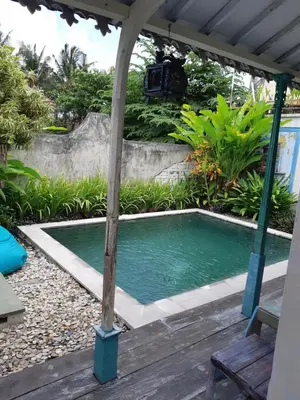 a small swimming pool under a pergola at HI Lonny Villa Seminyak in Seminyak