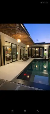 a house with a swimming pool in front of it at Vila Samatha 2 Nusa Dua in Nusa Dua