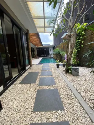 a courtyard with a pool in a house at Vila Samatha 2 Nusa Dua in Nusa Dua
