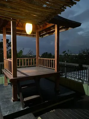 a wooden gazebo with a light on it at Vila Samatha 2 Nusa Dua in Nusa Dua