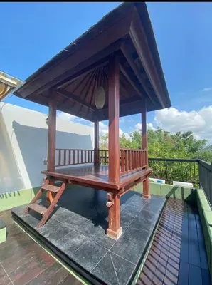 a wooden gazebo on the roof of a house at Vila Samatha 2 Nusa Dua in Nusa Dua