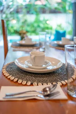 a table with a cup of coffee on top of it at Villa Kusuma 1 Seminyak in Seminyak