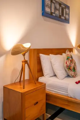 a bedroom with a bed with a wooden bed sidx sidx sidx at Villa Kusuma 1 Seminyak in Seminyak