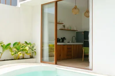a bathroom with a tub and a kitchen at NEW! Villa Imaera - 2BR Villa in Kerobokan in Kerobokan